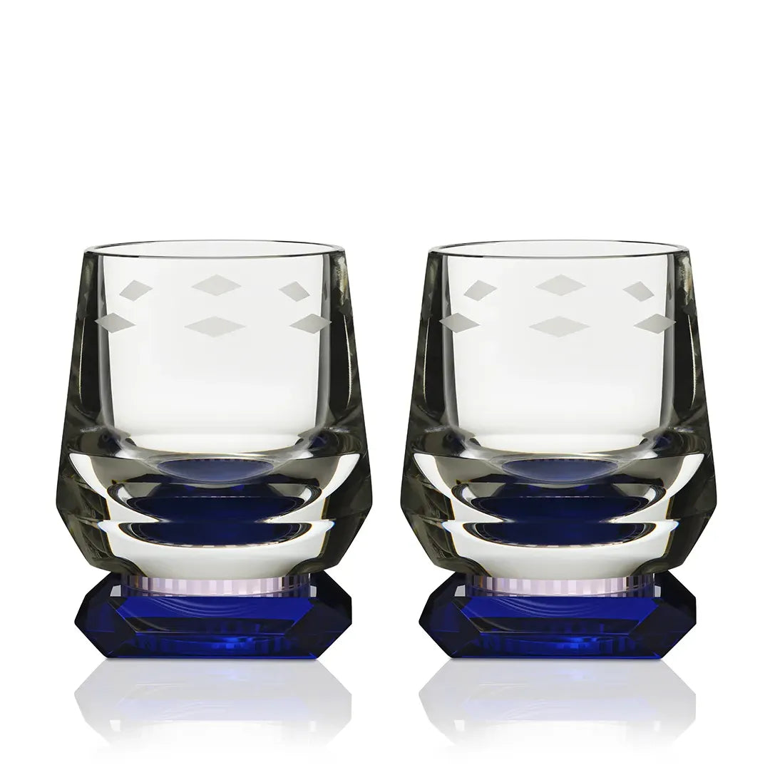A close-up of the Whimsy Blue Whisky Glass set, showcasing its crystal-clear design, diamond-cut facets, and deep blue base against a white background.