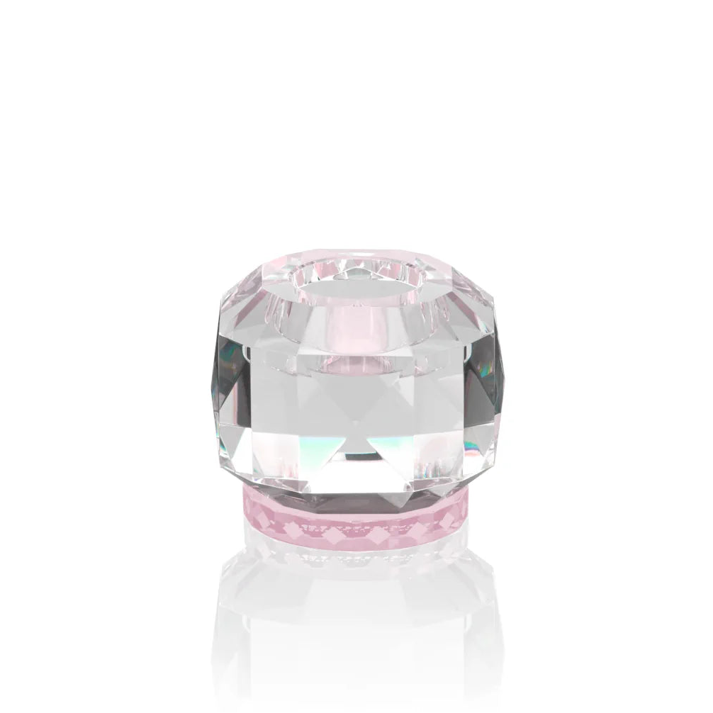A hand-cut crystal tealight holder with a geometric and jewelled form, featuring clear crystal and a rose-colored band.